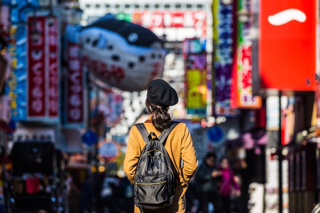 Female traveler walking safely through Shinsekai streets