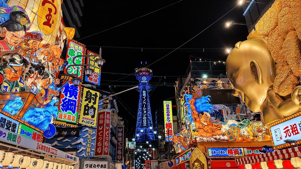 Tsutenkaku Tower illuminated at night in Shinsekai