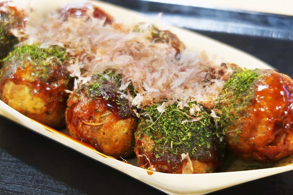 Fresh takoyaki being prepared at an Osaka street stall