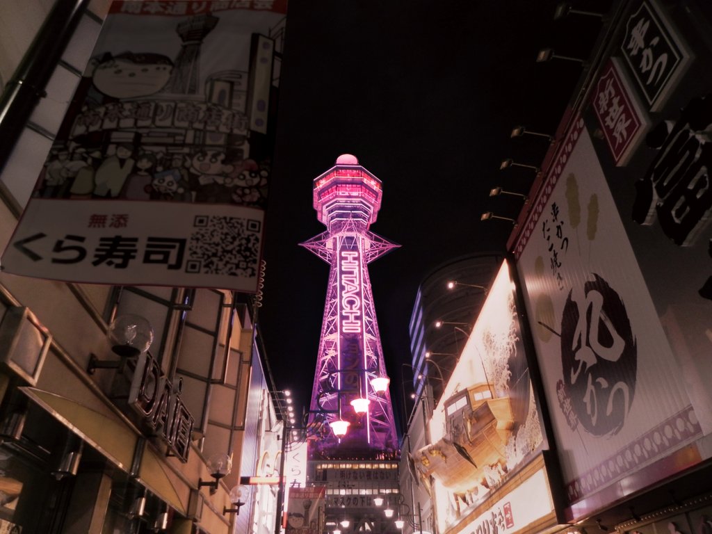 Tsutenkaku Tower illuminated at night in Shinsekai