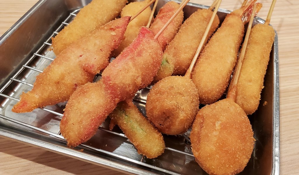 Travelers enjoying food in Osaka restaurant