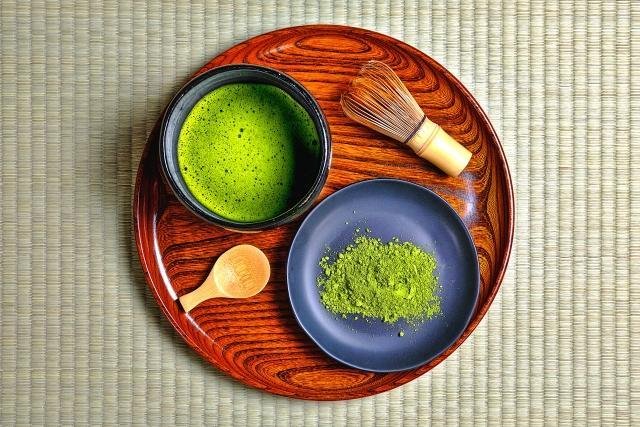 Whisking matcha tea at tea ceremony osaka workshop