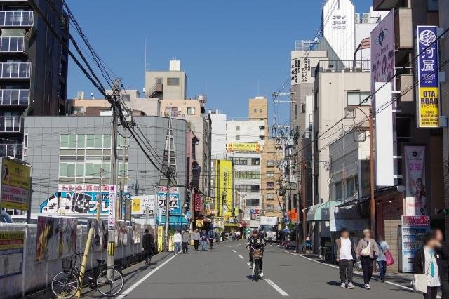 Travelers shopping at Den Den Town specialty shops