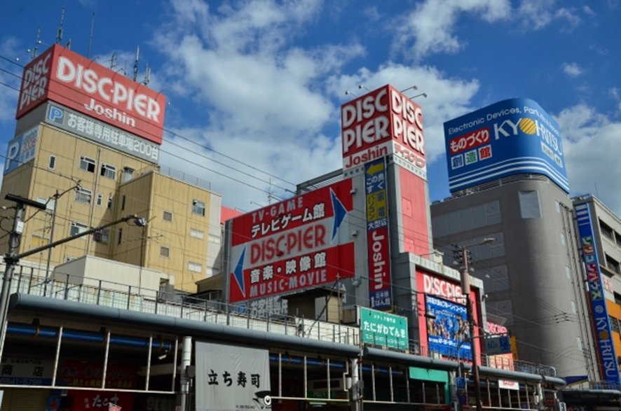 Street view of Den Den Town Osaka with electronics shops and signage