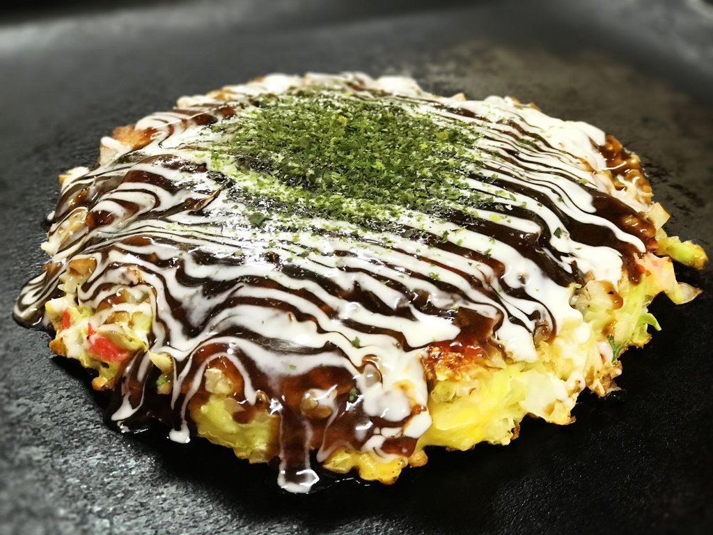 Enjoying okonomiyaki in Osaka restaurants