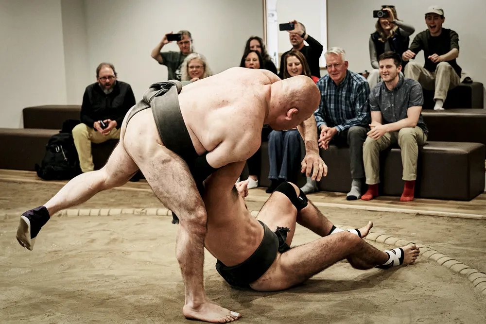 Former sumo wrestlers demonstrating at Sumo Wrestling Experience in Osaka